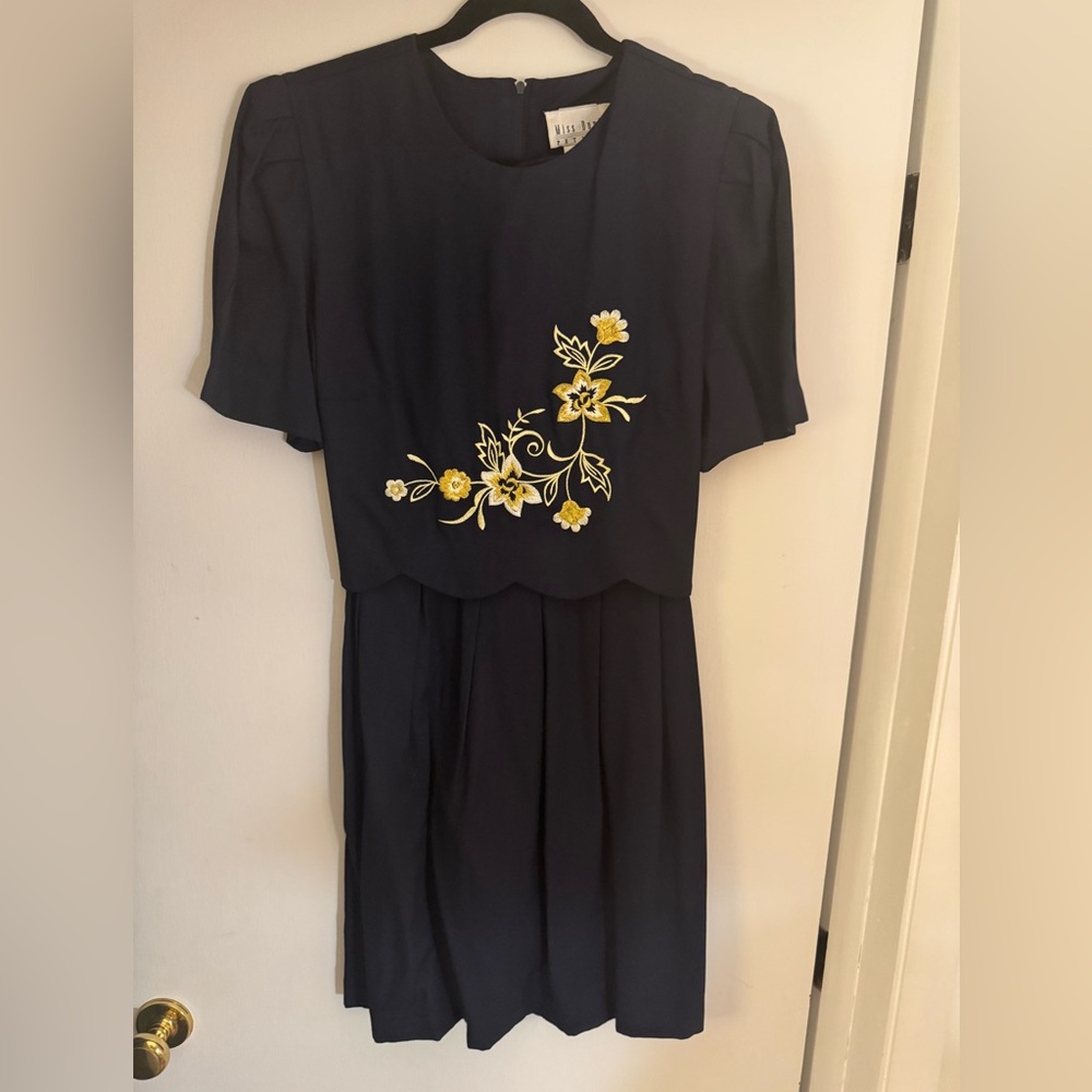 Vintage navy blue dress with flower detailing.